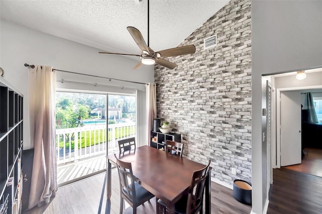 2937 Bough Ave Unit D, Clearwater, FL 33760 - dining area with ceiling fan, wood finished floors, a textured ceiling, lofted ceiling, and brick wall