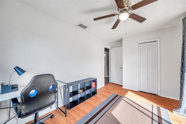 2937 Bough Ave Unit D, Clearwater, FL 33760 - home office featuring ceiling fan, wood finished floors, and a textured ceiling