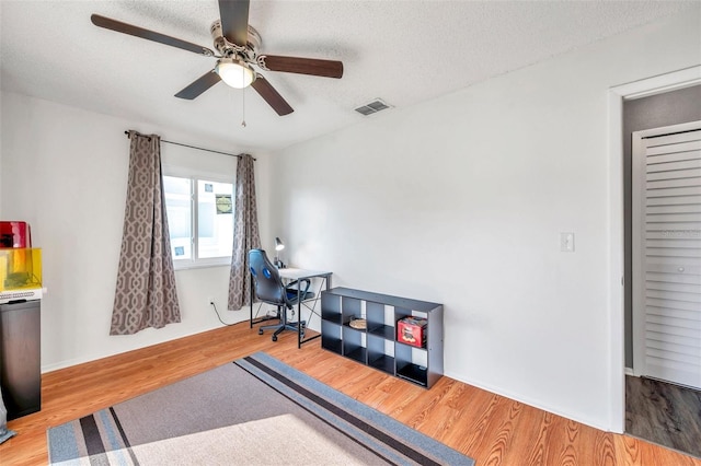 2937 Bough Ave Unit D, Clearwater, FL 33760 - home office featuring wood finished floors, ceiling fan, and a textured ceiling