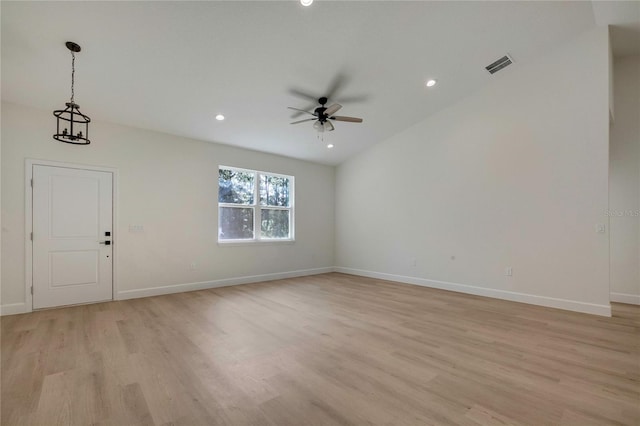 interior space featuring light hardwood / wood-style flooring and ceiling fan with notable chandelier