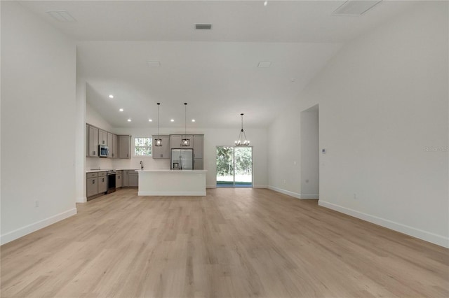 unfurnished living room featuring light hardwood / wood-style floors and lofted ceiling