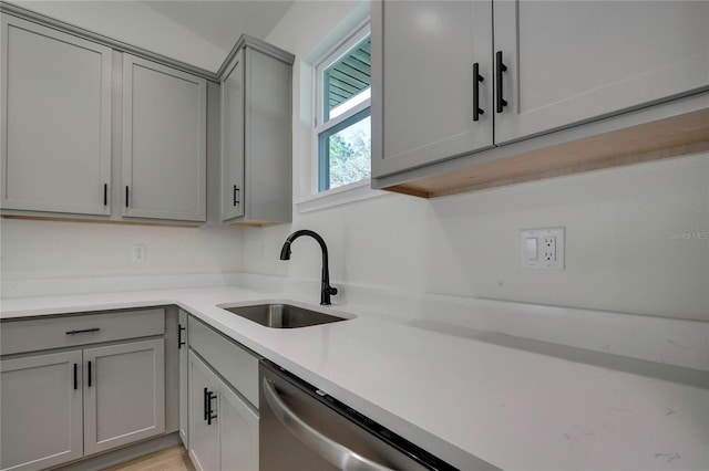 kitchen featuring gray cabinets, sink, light hardwood / wood-style flooring, and dishwasher