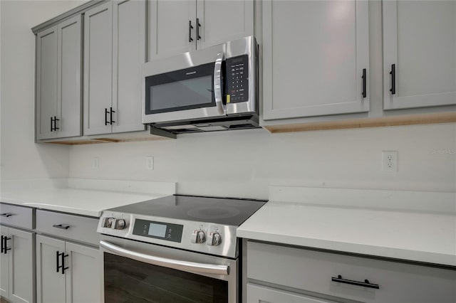 kitchen featuring appliances with stainless steel finishes and gray cabinetry