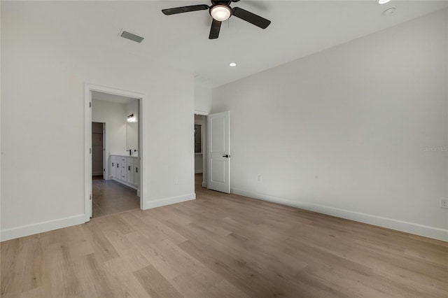 unfurnished bedroom with connected bathroom, light wood-type flooring, and ceiling fan