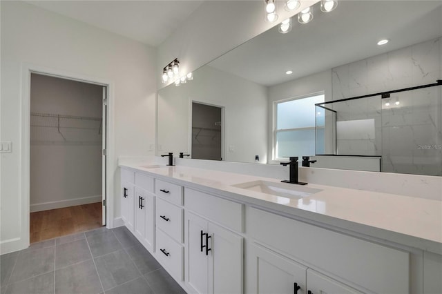 bathroom featuring vanity, tile patterned floors, and walk in shower