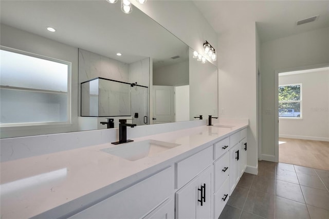 bathroom with vanity, an enclosed shower, and tile patterned flooring