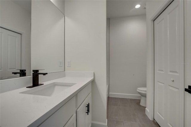 bathroom featuring vanity, toilet, and tile patterned floors