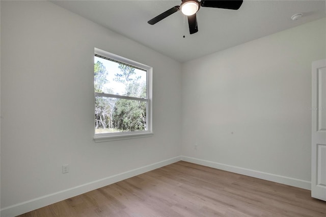 spare room featuring light hardwood / wood-style flooring and ceiling fan