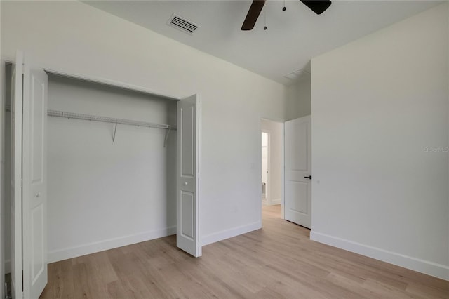 unfurnished bedroom with a closet, light wood-type flooring, and ceiling fan