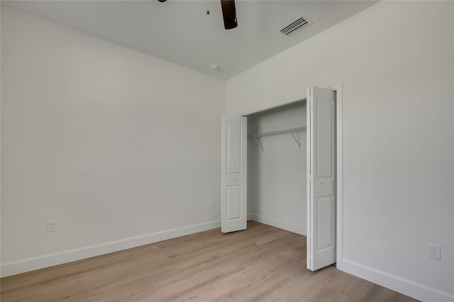 unfurnished bedroom with a closet, light hardwood / wood-style floors, and ceiling fan