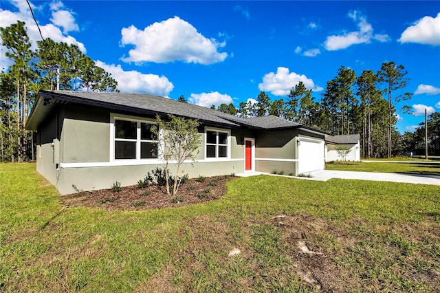 single story home featuring a garage and a front lawn