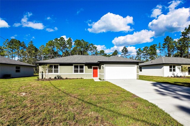 ranch-style home featuring a garage and a front lawn