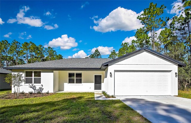 single story home with a garage and a front lawn