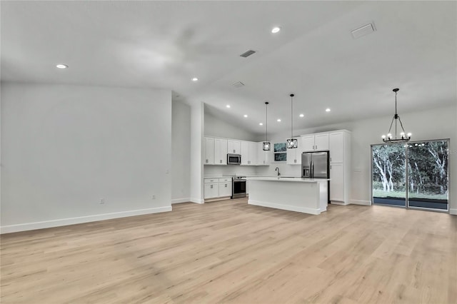 8118 N Santos Dr, Citrus Springs, FL 34434 - kitchen with stainless steel appliances, open floor plan, a chandelier, light wood finished floors, and recessed lighting