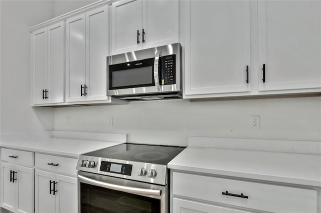 kitchen with white cabinetry and stainless steel appliances