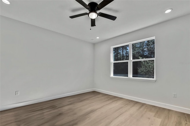 unfurnished room featuring light hardwood / wood-style flooring and ceiling fan