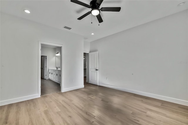 8118 N Santos Dr, Citrus Springs, FL 34434 - unfurnished bedroom with light wood finished floors, baseboards, recessed lighting, connected bathroom, and ceiling fan