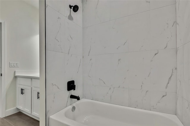 bathroom featuring vanity, tiled shower / bath combo, and tile patterned floors