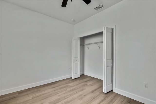 8118 N Santos Dr, Citrus Springs, FL 34434 - unfurnished bedroom featuring light wood-type flooring, baseboards, a closet, and a ceiling fan