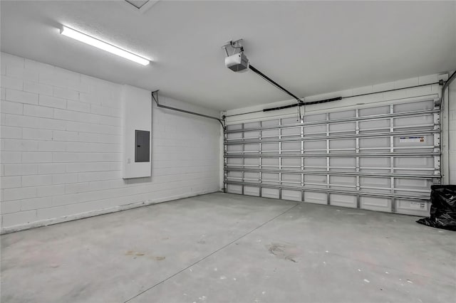 garage featuring electric panel and a garage door opener