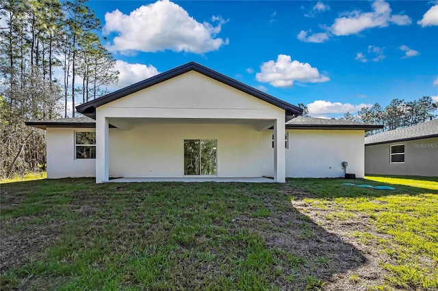 8118 N Santos Dr, Citrus Springs, FL 34434 - back of property featuring stucco siding, a yard, and a patio