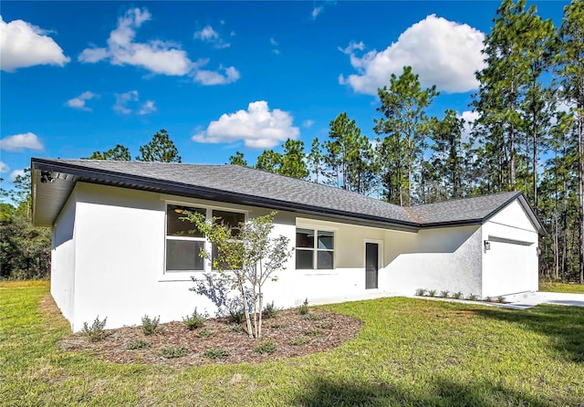 ranch-style home featuring a front yard and a garage