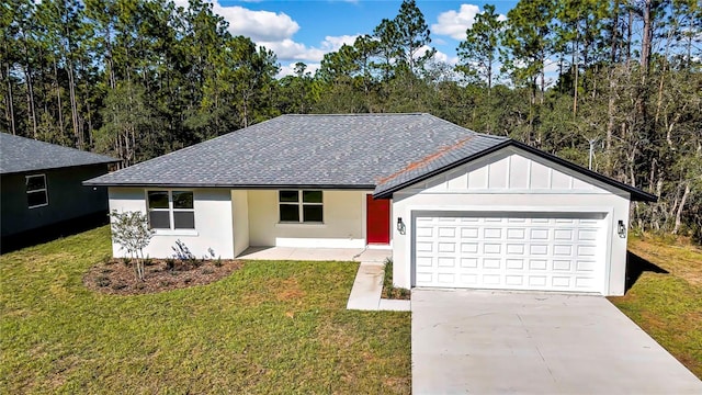 ranch-style house featuring a front lawn and a garage