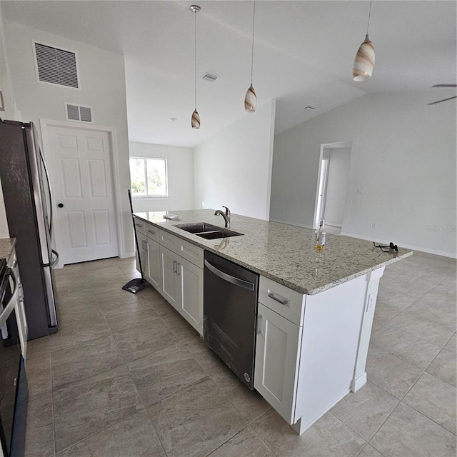 kitchen featuring an island with sink, white cabinetry, vaulted ceiling, sink, and stainless steel appliances