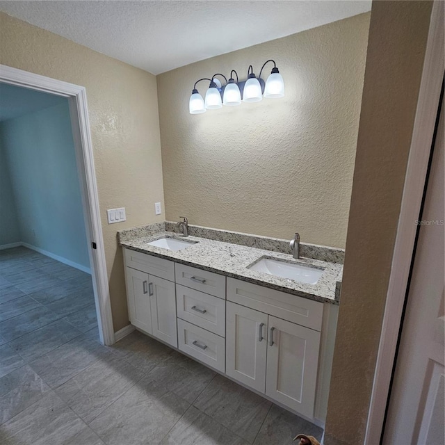 bathroom featuring vanity and a textured ceiling