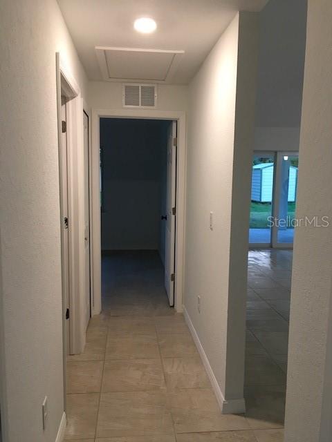 hallway featuring light tile patterned floors