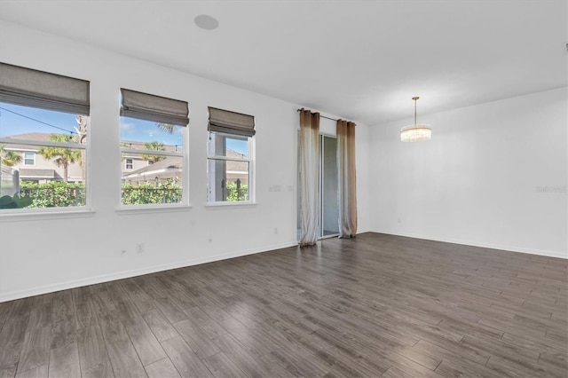 unfurnished room with dark hardwood / wood-style flooring