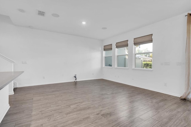 spare room with wood-type flooring