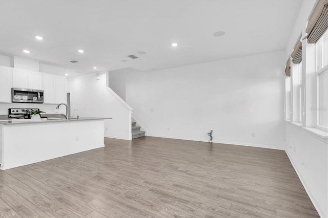 living room with sink and light hardwood / wood-style flooring