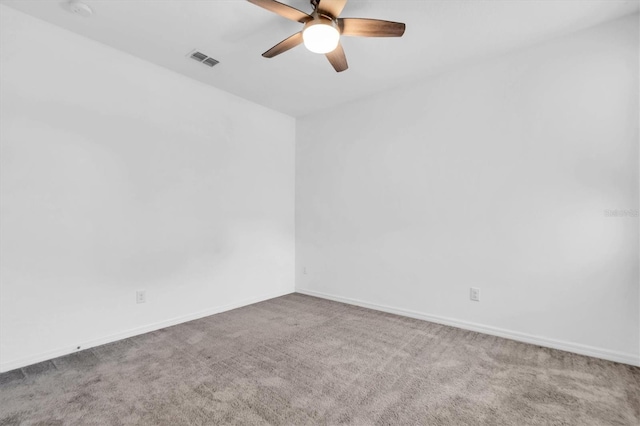 spare room featuring carpet and ceiling fan