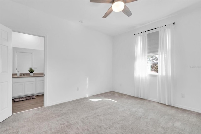 carpeted empty room featuring ceiling fan