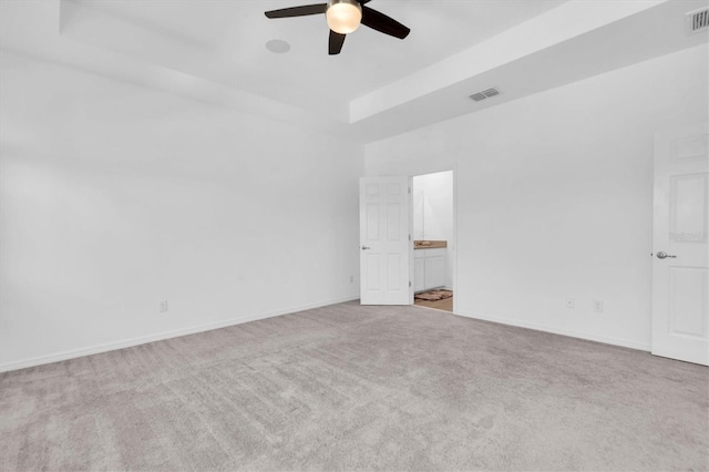 unfurnished room with light colored carpet and ceiling fan