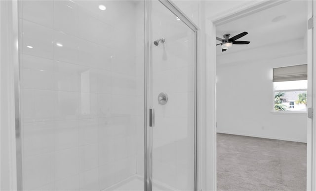 bathroom with ceiling fan and a shower with shower door