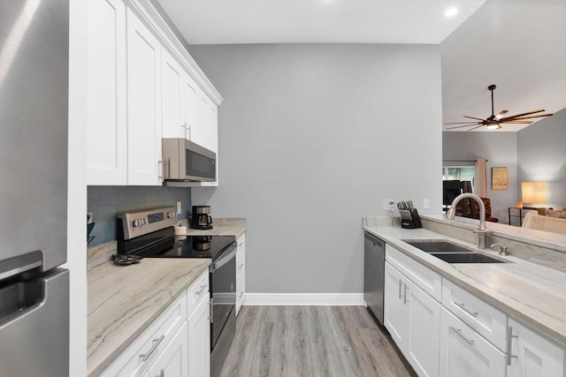 kitchen featuring white cabinets, sink, light hardwood / wood-style floors, and stainless steel appliances