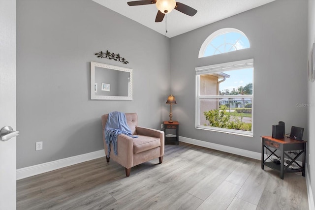 living area with plenty of natural light, ceiling fan, and light hardwood / wood-style flooring