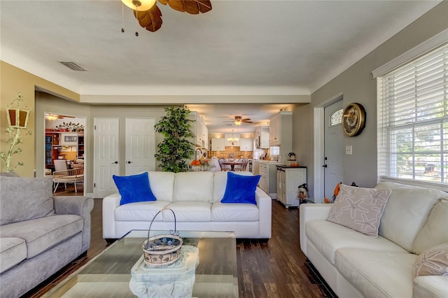 living room featuring dark hardwood / wood-style floors and ceiling fan