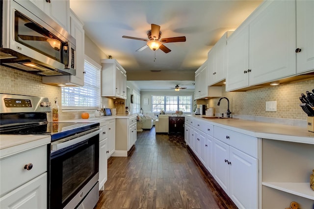 kitchen with a wealth of natural light, tasteful backsplash, appliances with stainless steel finishes, and sink