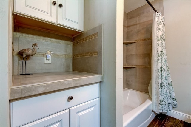 bathroom featuring wood-type flooring and shower / bath combination with curtain