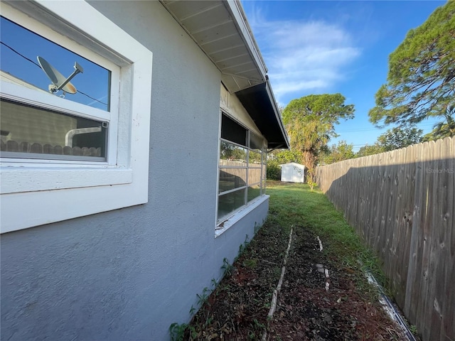 view of side of home with a storage shed