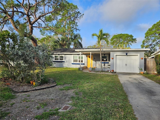 ranch-style house with a garage, a front lawn, and covered porch