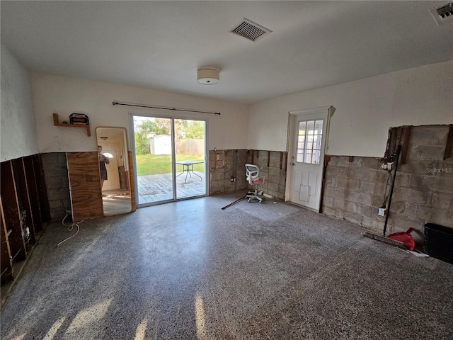 unfurnished living room featuring a wealth of natural light