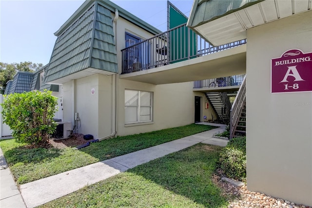 view of home's exterior featuring central AC and a lawn