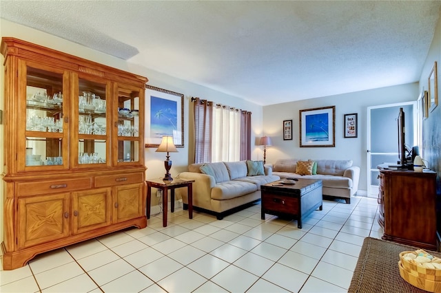 living room featuring a textured ceiling and light tile patterned flooring