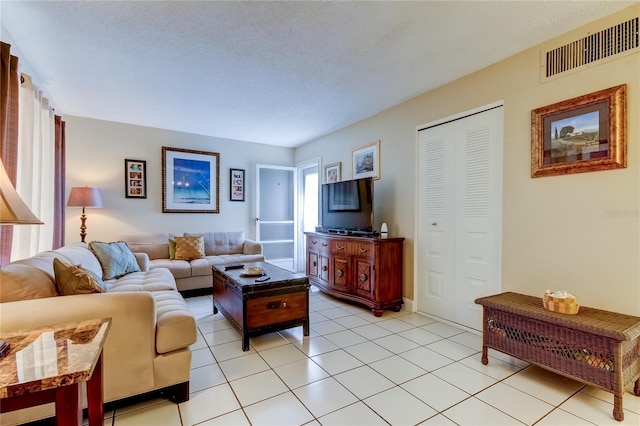 tiled living room with a textured ceiling