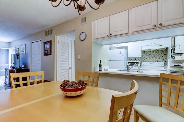 dining room with a textured ceiling and sink