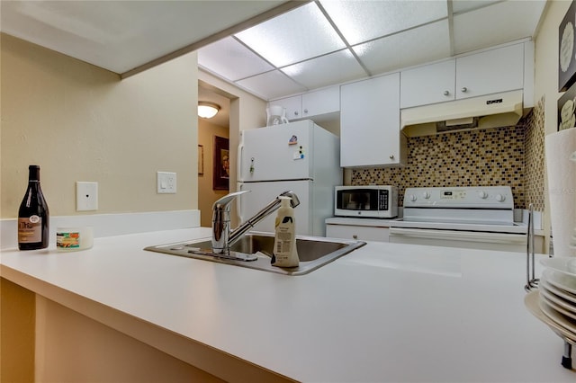 kitchen with backsplash, sink, a drop ceiling, white cabinets, and white appliances